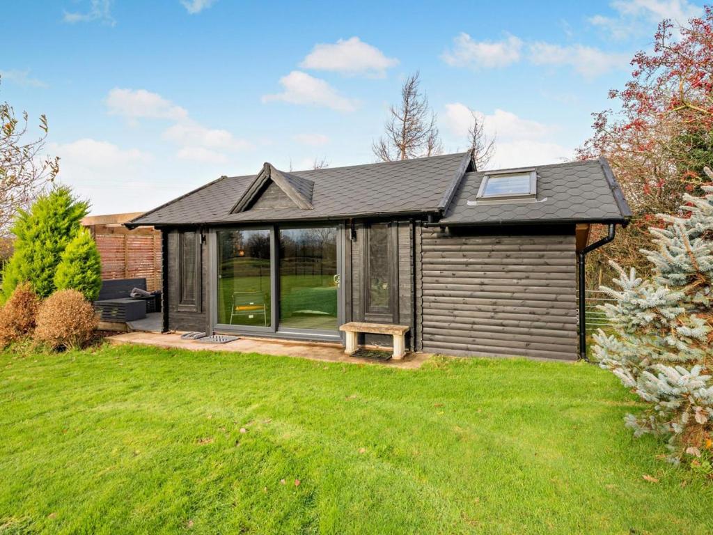 a small house with a garden and a lawn at 1 Bed in Maryport oc-96373 in Dearham