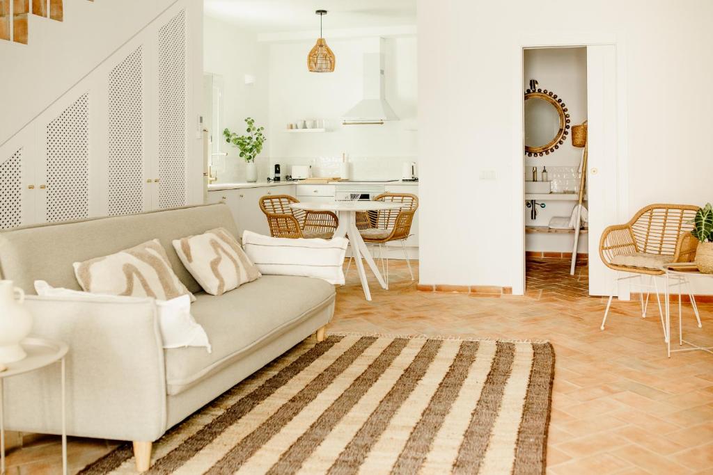 a living room with a couch and a table at Casa do Mar - Casas do Levante in Olhão