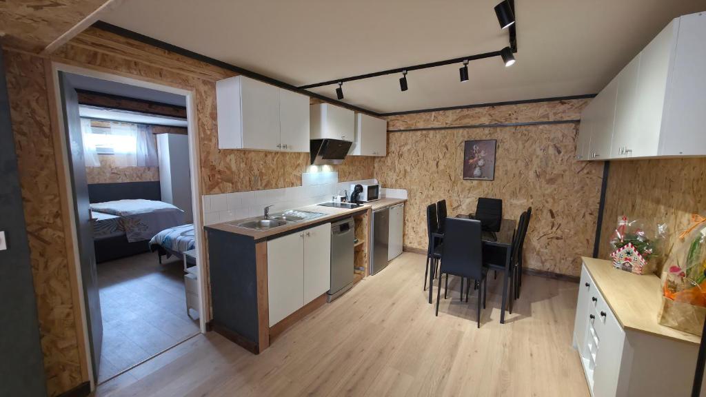 a kitchen and living room with a table and chairs at Chambre d'hôtes MA DAME in Clérey