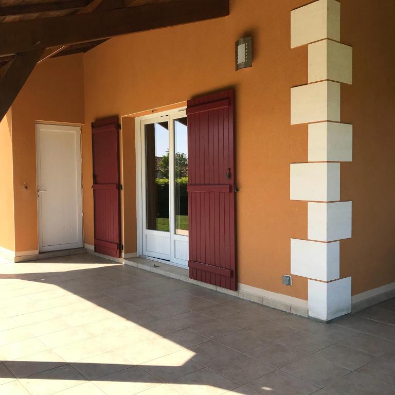 a building with two doors on the side of it at French country home II in Les Forges