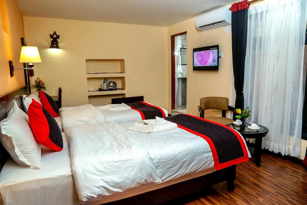 Postel nebo postele na pokoji v ubytování Taleju Boutique Hotel