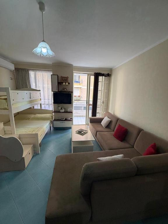 a living room with a couch and a bed at Aldi APARTMENTS in Lezhë