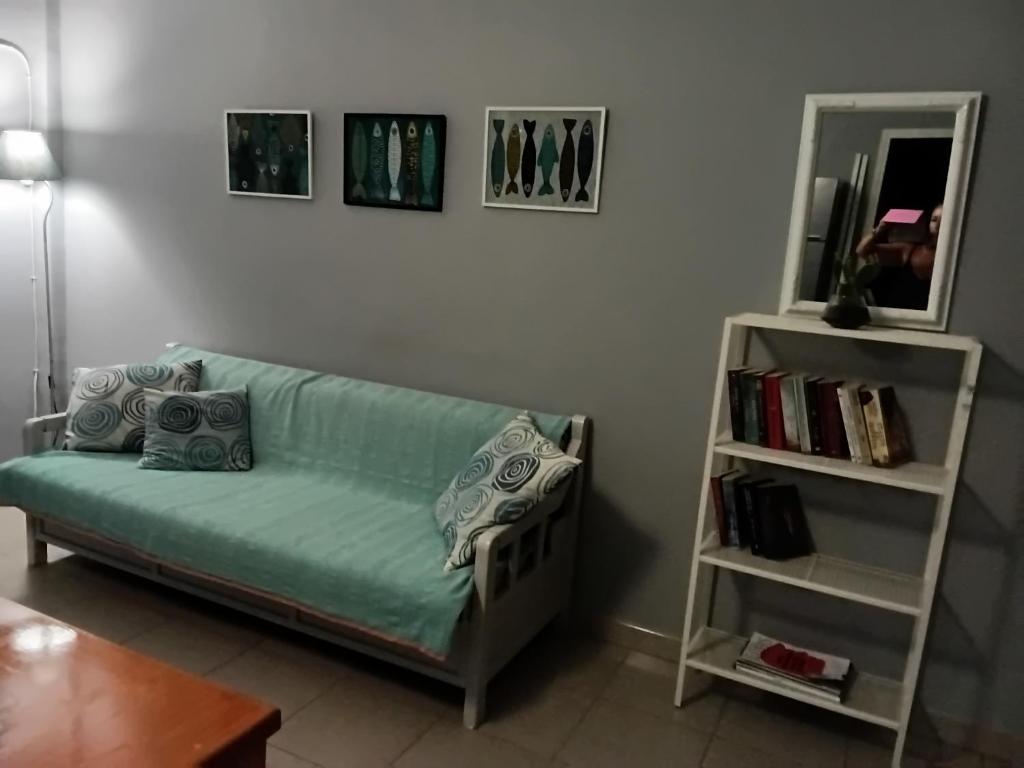 a living room with a couch and a book shelf at Kalli's View in Evdilos