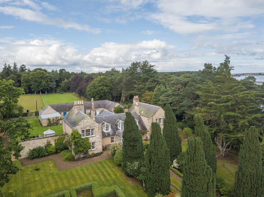 an aerial view of a house with trees at Binsness house in Findhorn