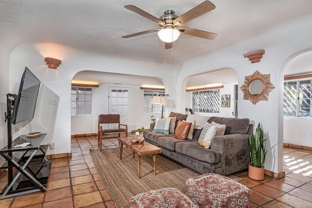 a living room with a couch and a ceiling fan at Sequoia Riverfront House With Beach Access in Three Rivers