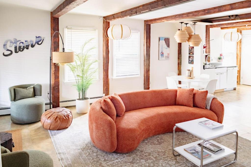 a living room with a couch and a table at Epic Apartment in Downtown Stowe in Stowe