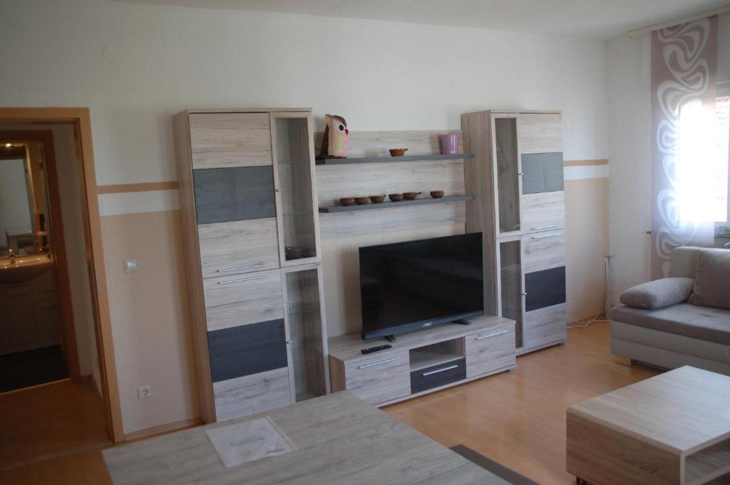 a living room with a entertainment center with a flat screen tv at Stylische Wohnung in Fellbach in Fellbach