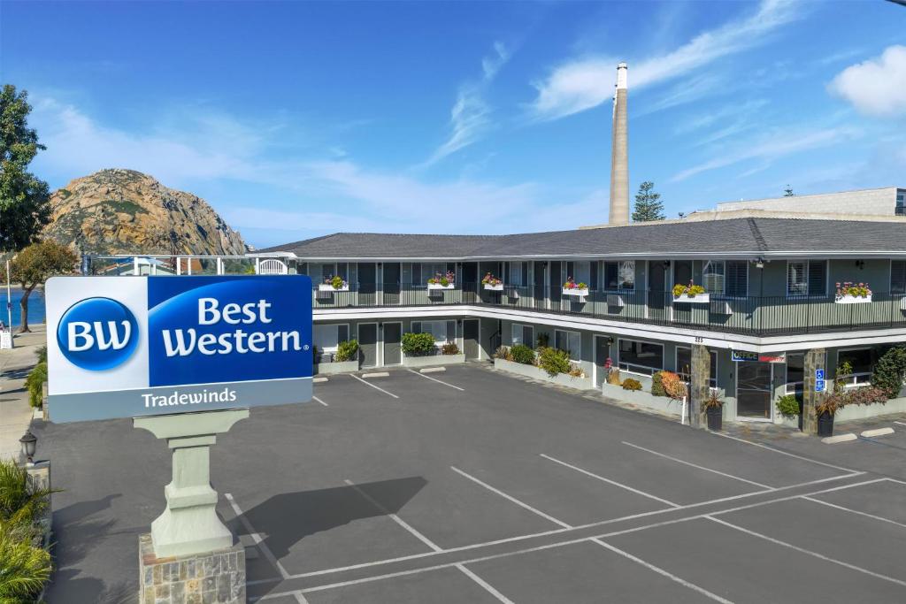 a hotel with a best western sign in a parking lot at Best Western Tradewinds in Morro Bay
