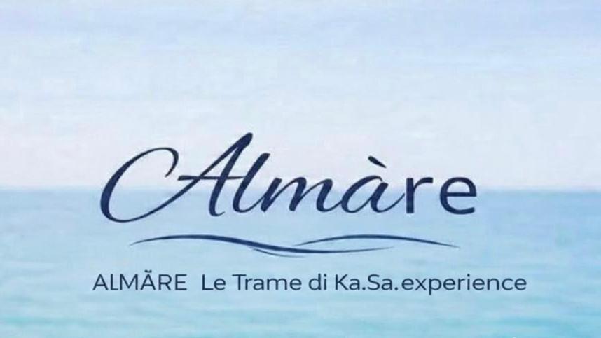 a sign that says alaminate with a picture of the ocean at ALMA'RE Le Trame di KaSa Experience in Porto Ottiolu