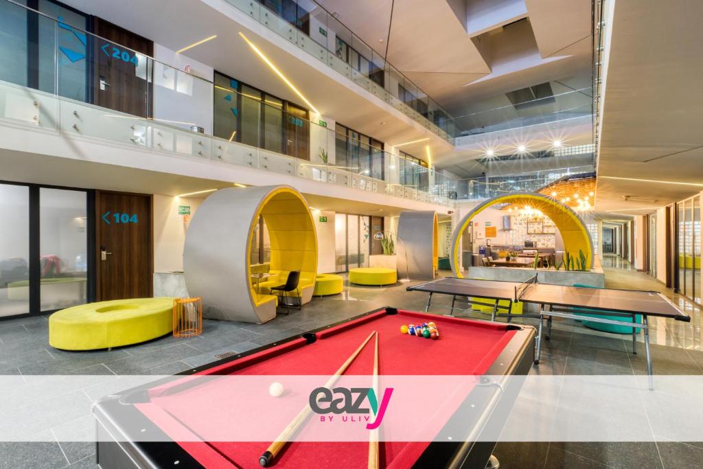 an office with ping pong tables and a pool table at Eazy Rio by ULIV in Tijuana