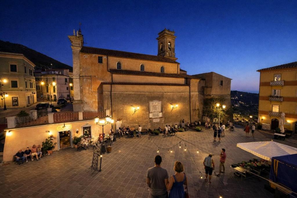 a group of people standing outside of a building at Borgo & Terrazza - Le Case di Rio in Rio nellʼElba