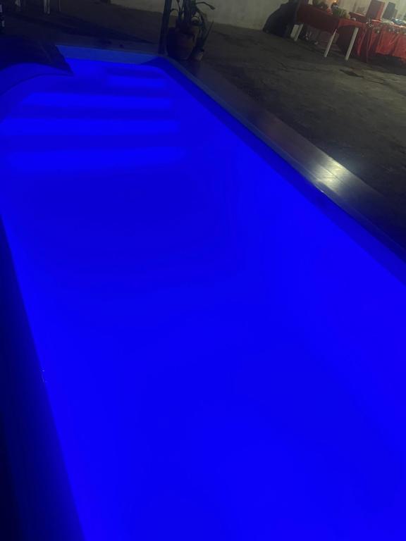 a swimming pool with blue lighting in a room at DK eventos in Teresina