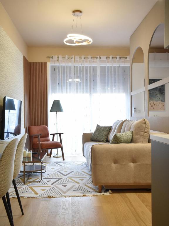 a living room with a couch and a chair at Montewave Studio Apartment in Boreti