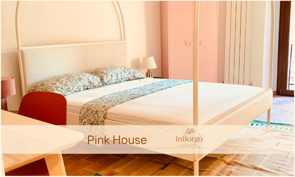 a bedroom with a pink house with a bed at Pink House - InBorgo in Acquasparta