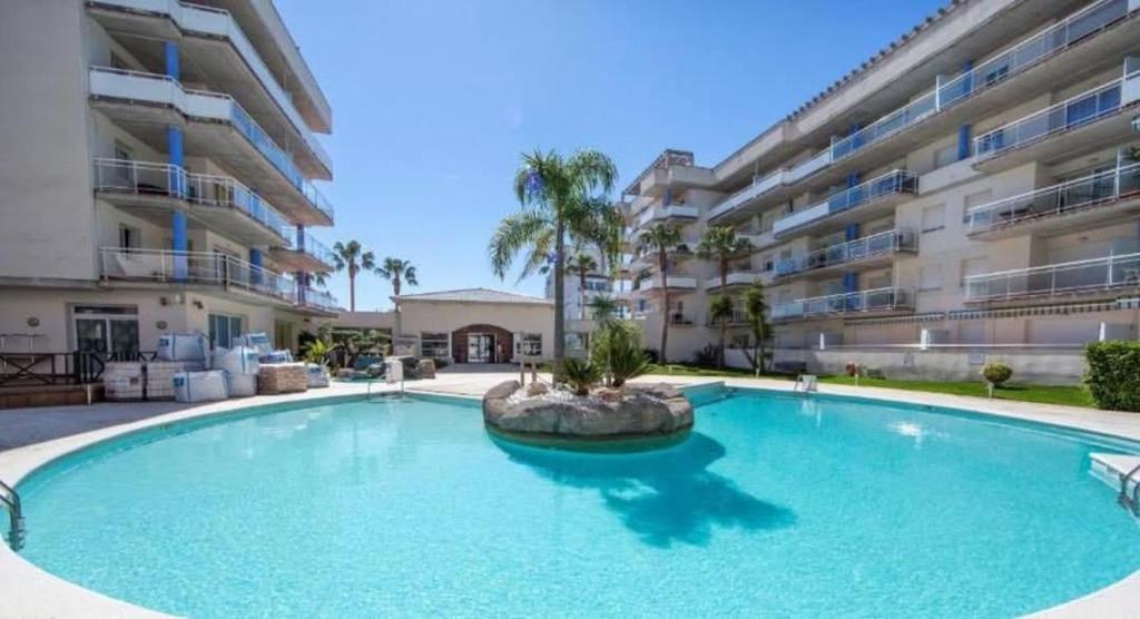 a large swimming pool in front of a building at La Casa Terracotta, ménage et linge inclus in Roses