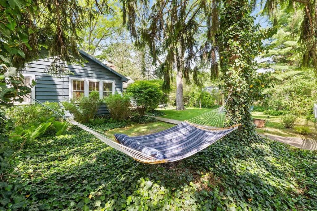 a hammock in a yard in front of a house at Nan's Escape by Juniper Holiday + Home in Union Pier
