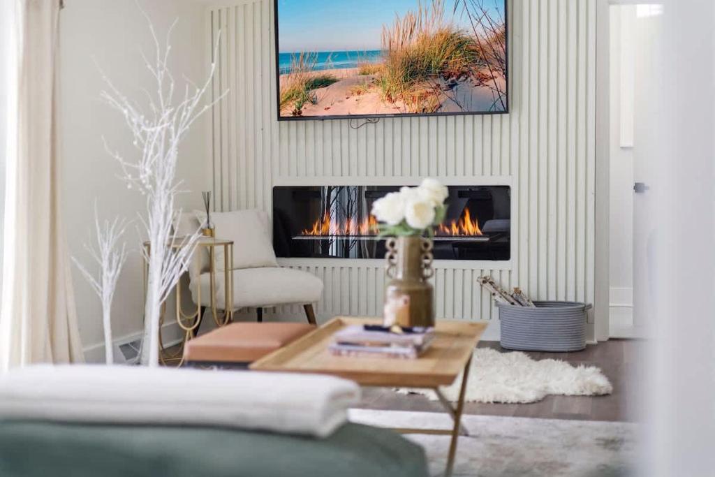 a living room with a coffee table and a fireplace at Cozy Haven in Three Oaks