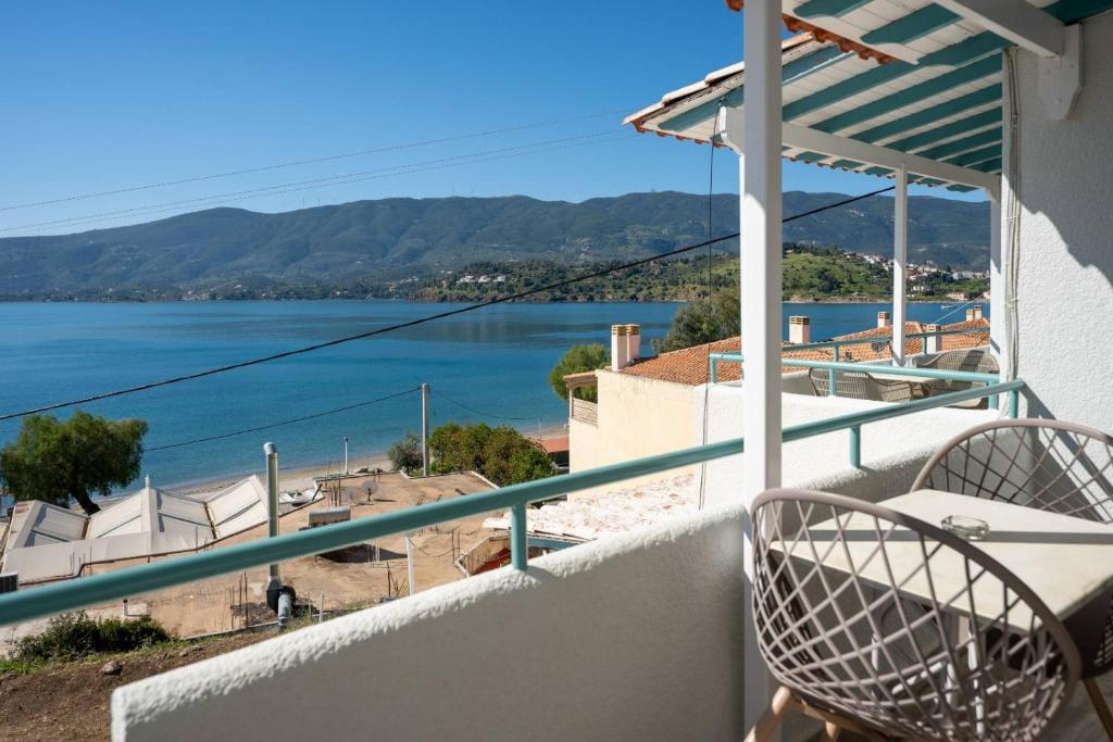 a balcony with a view of the water at Theodora Rooms in Poros