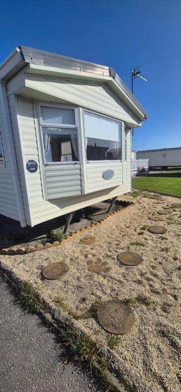 a tiny house sitting on the side of a road at The salsbury lyons robin hood park,rhyl in Meliden