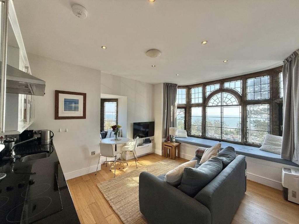 a living room with a couch and a table at 4 Coram Tower in Lyme Regis