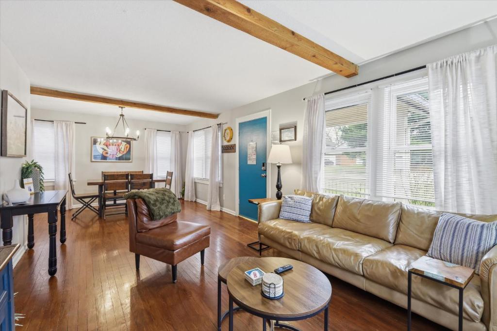 a living room with a couch and a table at Waldo Craftsman - Fenced yard Walkable to dining in Kansas City
