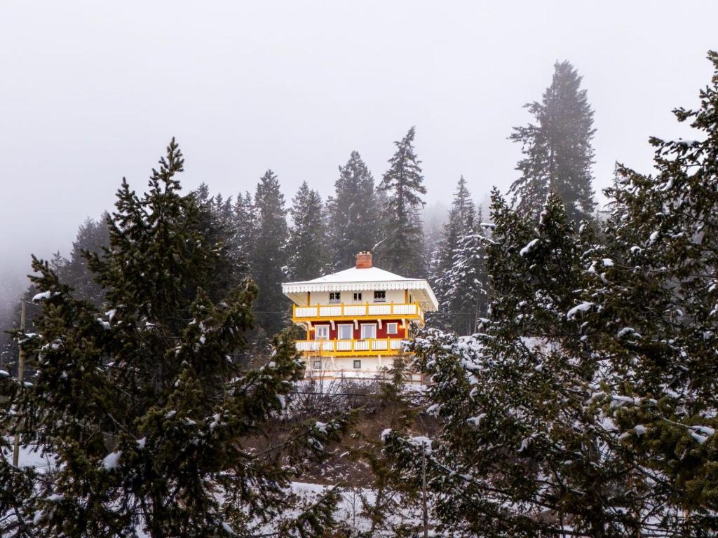 a house on top of a hill in the snow at Edelweiss Village & Resort – Chalet Aemmer in Golden