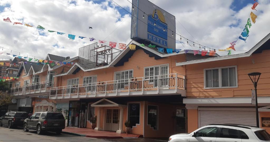 a building with a sign on the side of it at Hotel Villa Fontana Inn in Ensenada