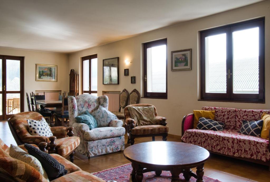 a living room with couches and chairs and a table at La grande Valsassina - Salone in Pasturo