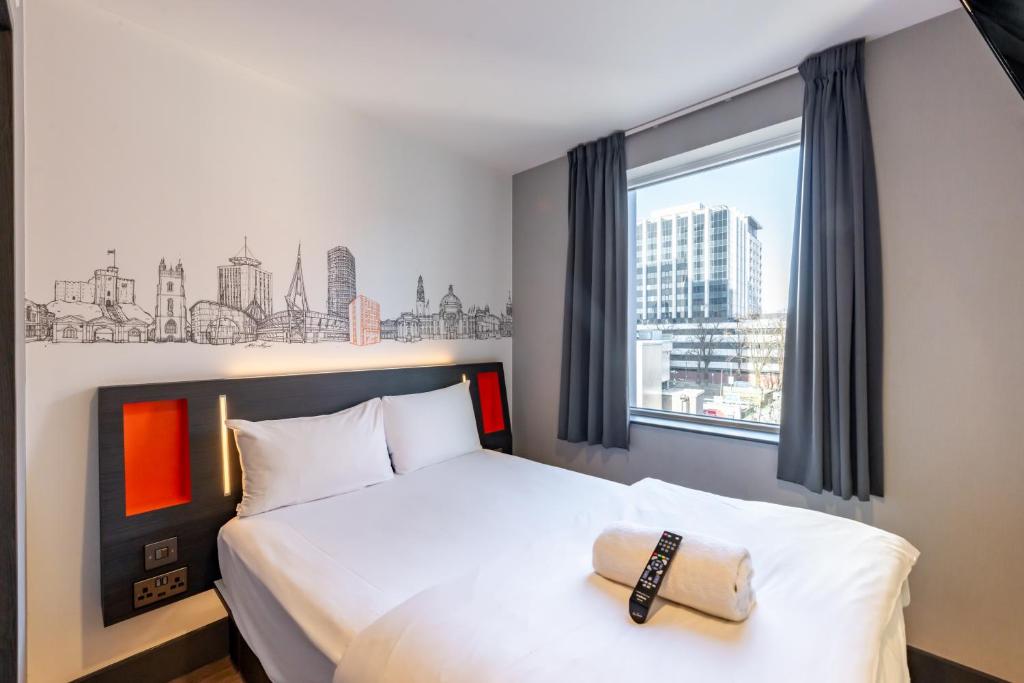 a hotel room with a bed and a window at easyHotel Cardiff in Cardiff