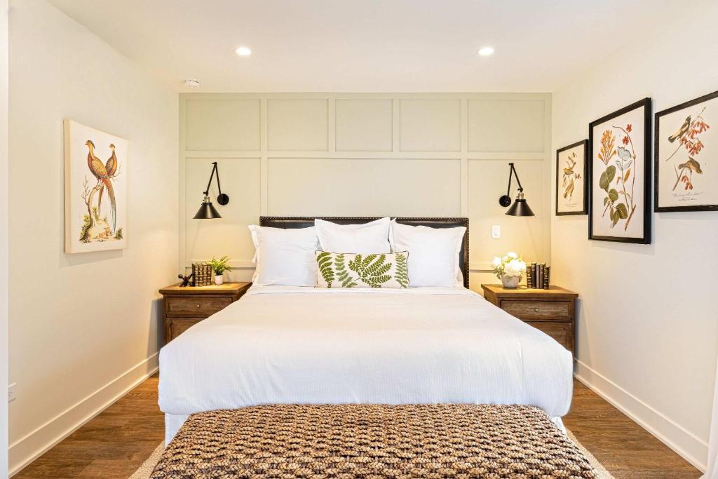 a bedroom with a large white bed with two night stands at Kildahl House - Boutique Farmhouse Suite #2 in West Dundee