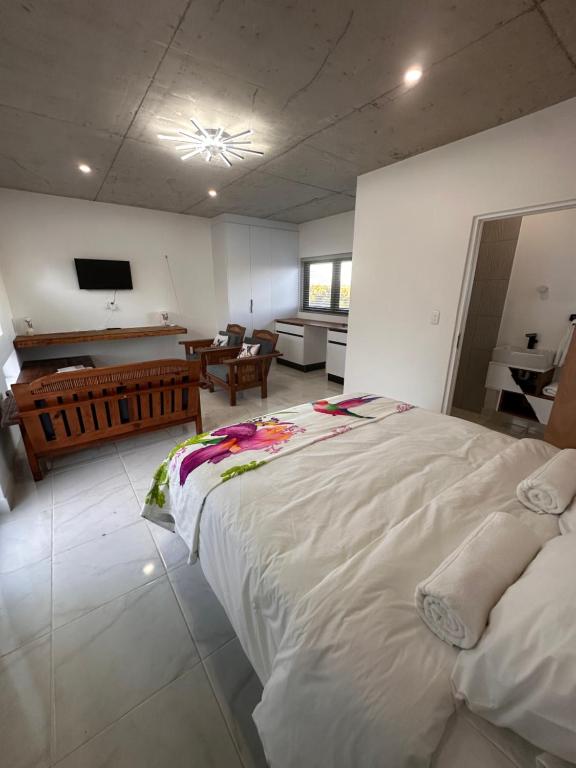 a bedroom with a large white bed in a room at Our Little Cottage in George