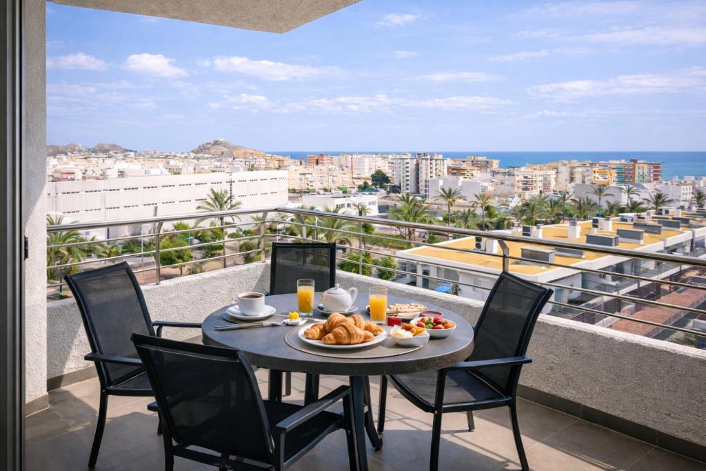 a table with a plate of food on a balcony at La Loma in Águilas