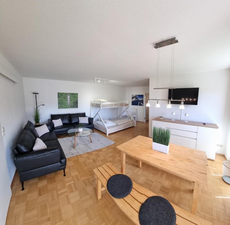 a living room with a couch and a table at Richters Alpen Appartement in Buchenberg