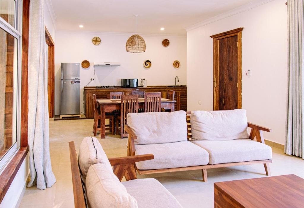 a living room with a couch and a table at Kikoi Boutique Hotel in Michamvi
