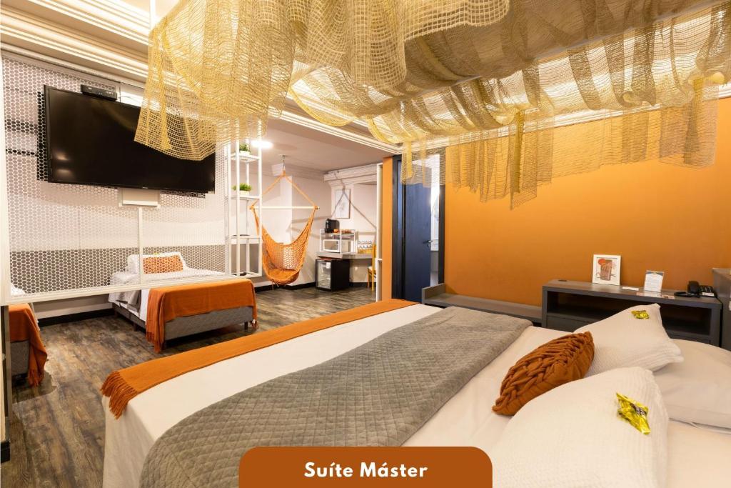 a hotel room with two beds and a flat screen tv at Camboriú Praia Hotel in Balneário Camboriú