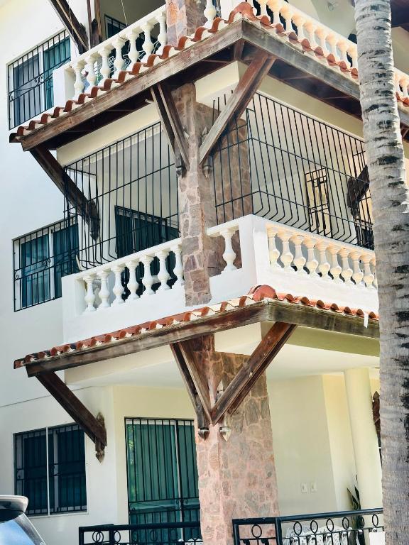 a building with a balcony on the side of it at Papagayo in Bayahibe