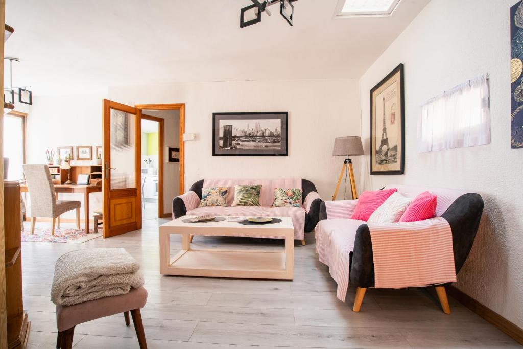 a living room with a couch and a table at Acogedora casa histórica en Segovia by CABANA Rentals in La Lastrilla