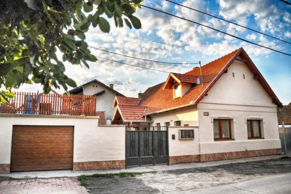 a white house with a brown roof at Zlatna Vila 2 in Kanjiža