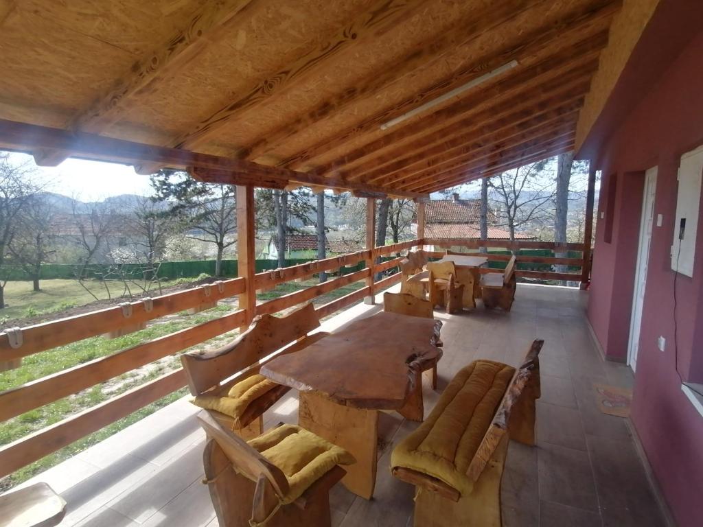 a large room with a wooden table and chairs at Suncani breg in Ljig