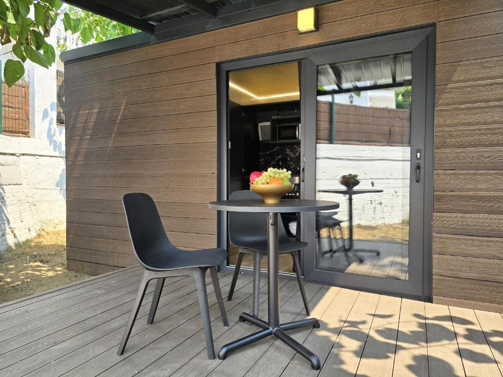 a table and two chairs on a patio at Camping Costa Dorada Tiny Amaia in Canet de Mar