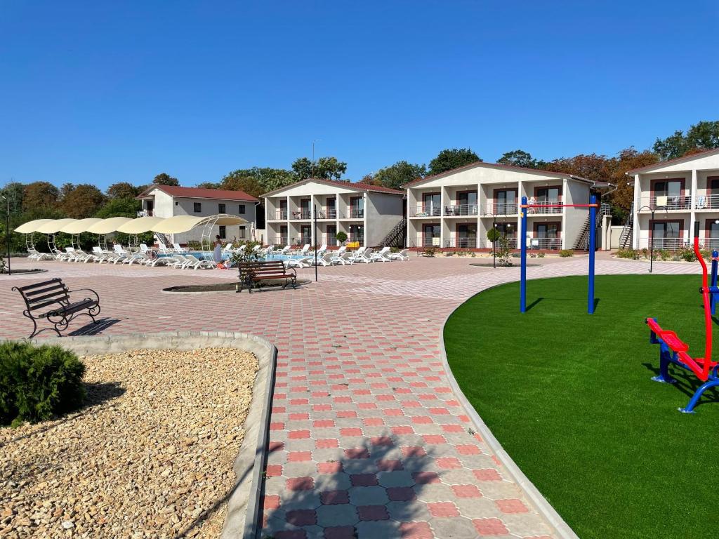 a park with benches and tables and a playground at Anna Mariya Villa in Kurortne