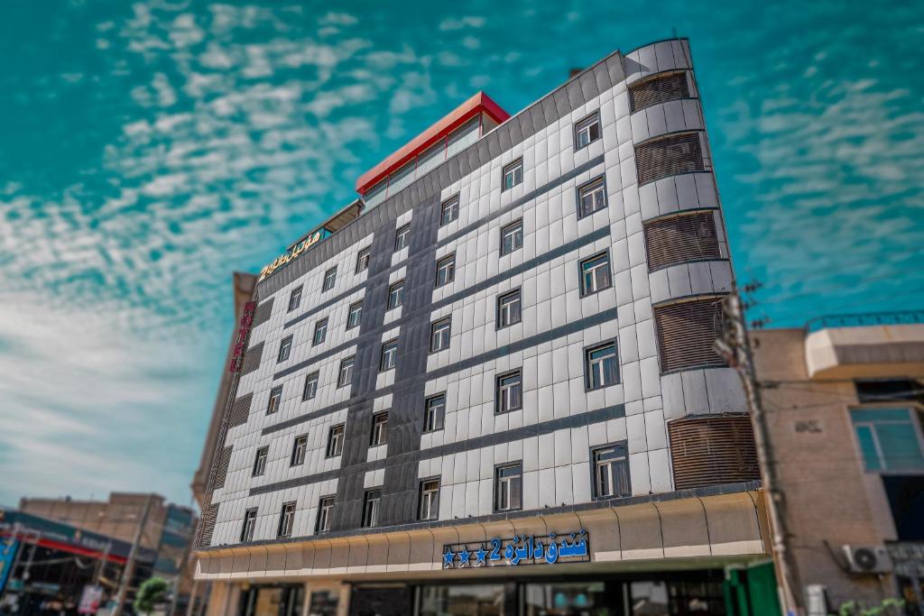 a tall white building on a city street at Hotel Danzha2 Erbil in Erbil
