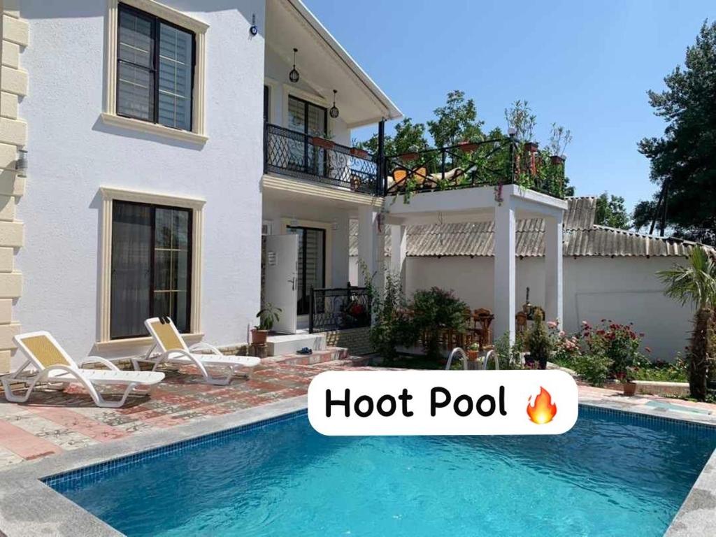 a house with a hot pool in front of it at Qafqaz mountain villa in Mekhrably