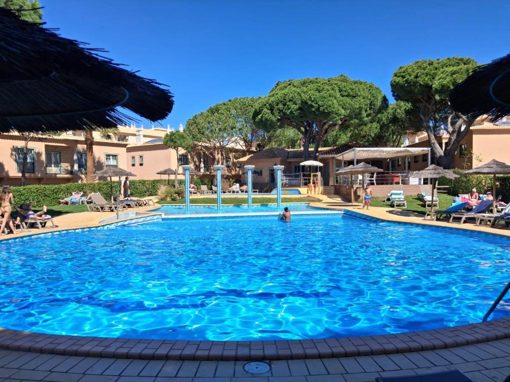 a swimming pool at a resort with blue water at 2 bed appartment, close to the beach in Albufeira