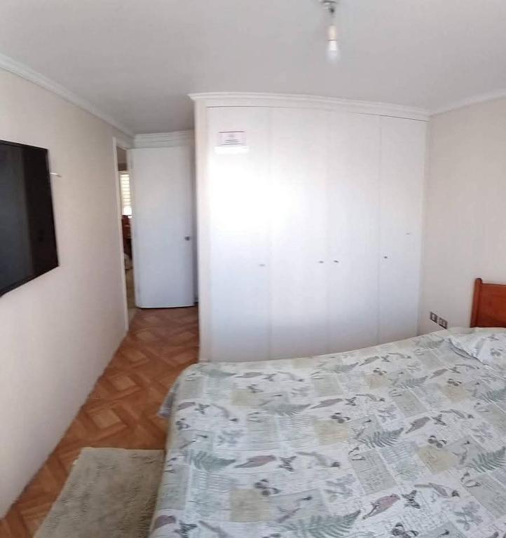 a bedroom with a bed and a television in it at Isabel de la serena in La Serena