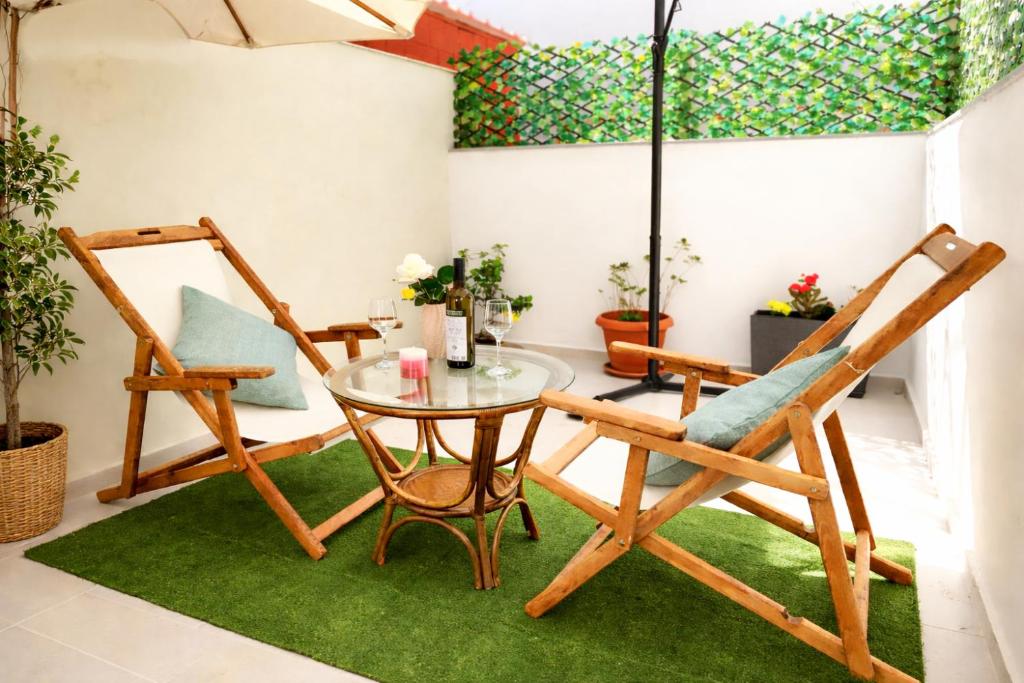 a room with two chairs and a glass table at Studio with Patio - 3 min Walk to Beach - Diamond 2 in Kardamaina