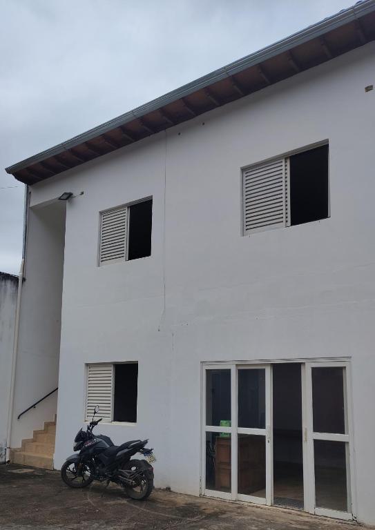a motorcycle parked in front of a white building at Pousada dos Cuiabás in Tiradentes