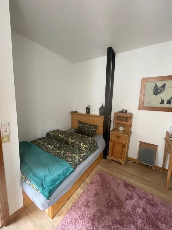 a small bedroom with a bed and a night stand at Gasthaus Liam 2 in Bendorf