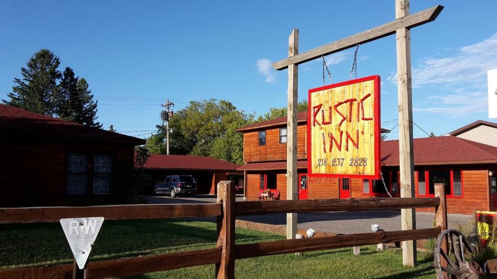 a sign on a fence in front of a church at Rustic Inn in Park Rapids