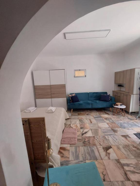 a living room with a blue couch and a table at Studio Casa Tropicana in Paul do Mar